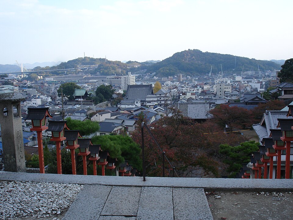 Temple rooftops and Onomichi town overlooking the channel and Mukaishima in afternoon light