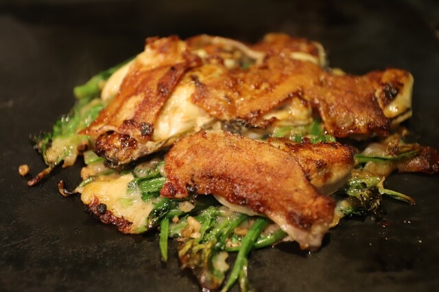 Okonomiyaki topped with pork at Moriguchi