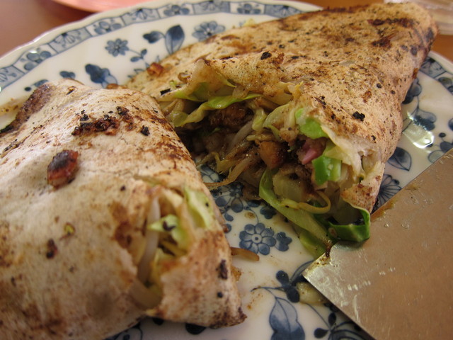 Sliced okonomiyaki showing the filling at Yamaguchi Okonomiya