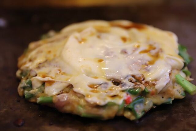 Okonomiyaki topped with egg at Sougetsu