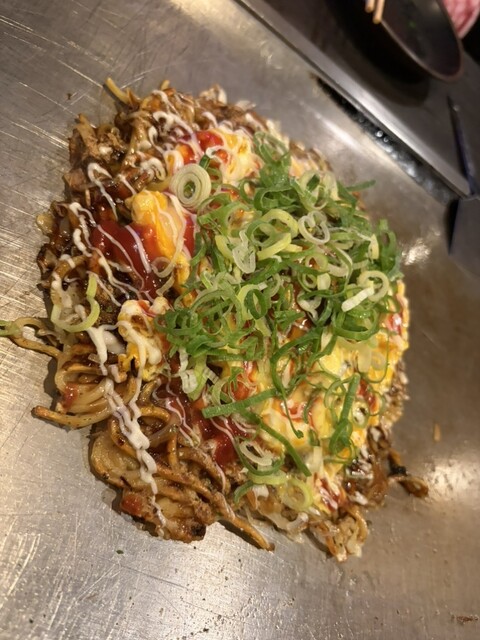 Okonomiyaki with noodles and green onions at Teramae