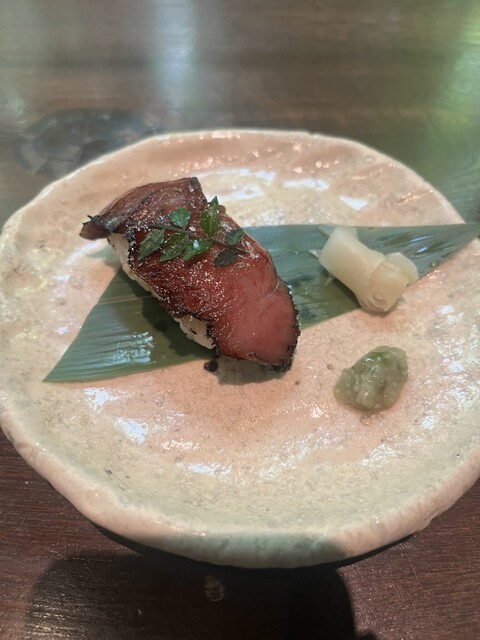 Sliced beef served with condiments at Hidagyu Grill Bakuro