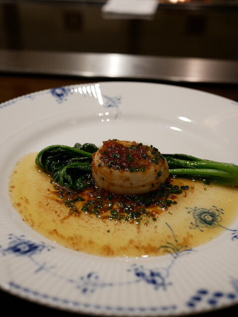 A plated dish with sauce and greens at Yokohama Ukai-tei