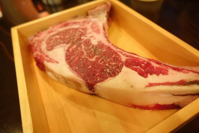 Marbled bone-in beef prepared for cooking at AKAMIYACOWSI