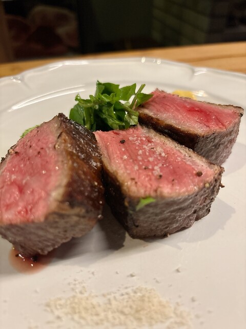 Sliced steak showing a pink center at STEAK HOUSE NARIKIYO